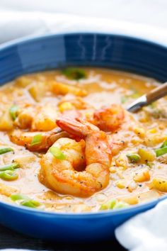 a bowl of soup with shrimp and vegetables