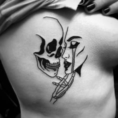 a woman's back with a skull and two faces on her side, in black and white