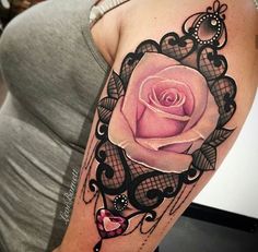 a woman with a pink rose tattoo on her arm and shoulder, next to a black lace border