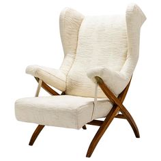 an upholstered white chair with wooden legs