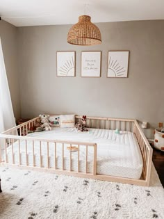 a baby crib in the corner of a room with two pictures on the wall