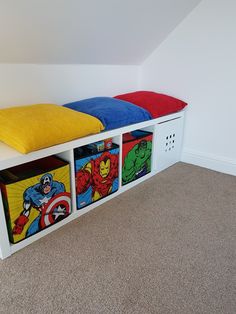 a toy storage bench with three bins and superhero images on the sides