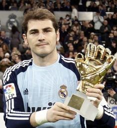 a man holding a golden glove in front of a crowd