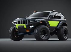 a black and green jeep with four wheels on a dark background, it appears to be an off - road vehicle