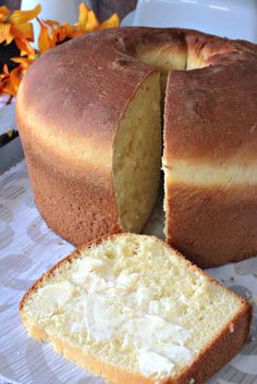 a loaf of bread sitting on top of a table next to a piece of cake