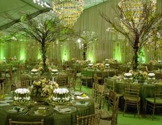 the tables are set with green linens and centerpieces for an elegant reception