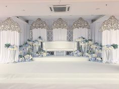 a white stage set up with blue and white flowers