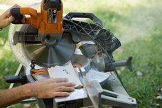 a man using a circular saw to cut wood