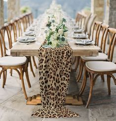 the table is set with an animal print runner