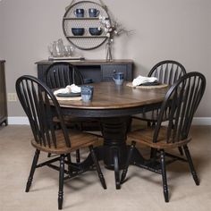 a dinning room table with chairs around it