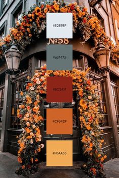 an orange and yellow color scheme on the side of a building with lots of flowers