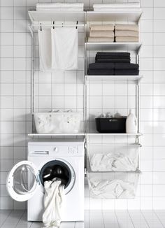 a washer and dryer sitting next to each other in front of a white tiled wall