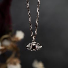 Evil eye amulet. For centuries, eye symbols are used for protection and power. If out of stock, it will be made to order. Please allow 3-4 weeks production time as each piece is created just for you. Contact us if you need longer chain. Garnet = 3mmPendant = 7mm x 11mmChain length = 16" Handmade in NYC Evil Eye Amulet, Goth Necklace, Eye Symbol, Tool Gifts, Bracelet Collection, Sterling Silver Charm, Signet Ring, Men Necklace, Silver Bracelets