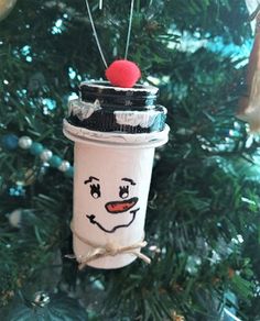 a christmas tree ornament with a coffee cup in the shape of a face