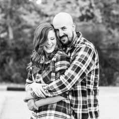 a man and woman hugging each other in black and white