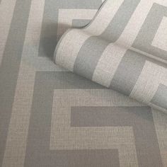 a close up view of a grey and white fabric with an interlocked design