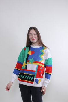 Hi! This is vintage from 90s cute cozy sweater in white color with abstract multicolor print. This top made of COTTON, RAYON and POLYACRYL. The model in the photo is 170 cm tall and is wearing a SMALL size shirt.  ( S - size on the tag). But, be careful, this is a vintage size, it is better to check the measurements below in the product description. Sleeve - 50cm / 19.68inch; Width - 55cm / 21.65inch; Length - 70cm / 27.55inch. All measurements are taken seam to seam while lying flat. Sleeve mea Trendy Multicolor Sweater With Graphic Print, Trendy Patterned Crew Neck Sweater, Casual Multicolor Graphic Print Sweater, Playful White Sweater With Graphic Print, Fun Winter Sweater With Graphic Print, Fun Graphic Print Winter Sweater, White Crew Neck Sweater In 90s Style, Multicolor Graphic Print Sweater For Fall, Multicolor Graphic Print Sweater For Spring