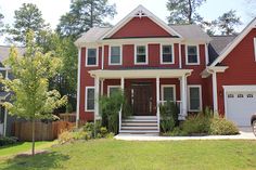 a red two story house with white trim