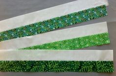 three strips of green and white fabric on top of each other