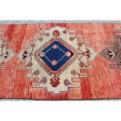 an old rug with many different colors and designs on it's sides, including blue in the middle