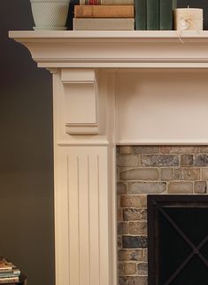 a fire place with a clock on top of it next to a fireplace mantel