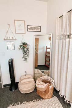 there is a basket on the floor in front of a mirror and some other items