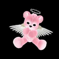 a pink teddy bear with angel wings and a chain around it's neck on a black background