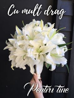 a person holding a bouquet of white flowers