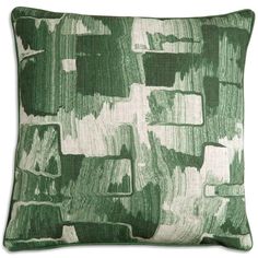 a green and white pillow with an abstract design on the front, featuring square shapes