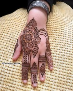 henna tattoo on the palm of someone's hand