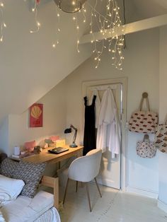 a bedroom with a bed, desk and hanging lights