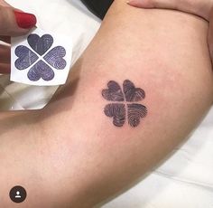 a person with a four leaf clover tattoo on their arm