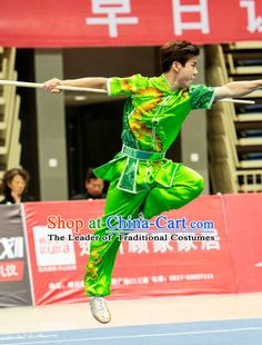 a man in green and yellow doing tricks on a tennis court with his racket