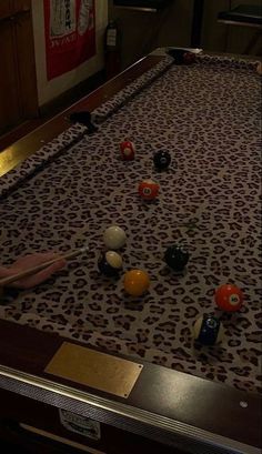 a pool table with balls and cues on it