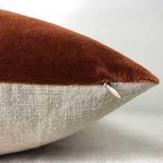 a brown and white pillow sitting on top of a table