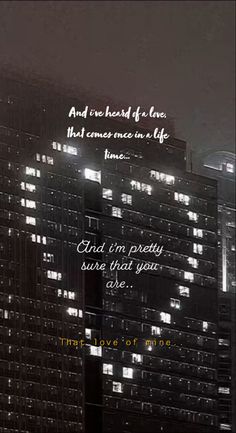 an image of a city at night with the words, and i've heard of love that comes once in a life