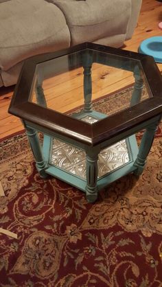 a coffee table with glass top sitting on a rug