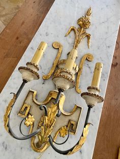 an ornate gold and white chandelier on a marble table