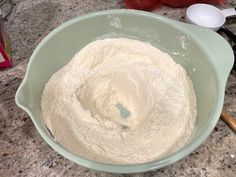 a bowl filled with flour sitting on top of a counter