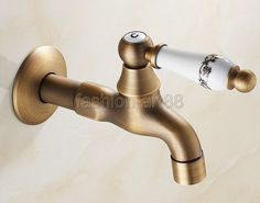 the faucet is attached to the wall and has a sprayer in it