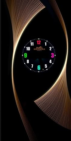 a clock that is on the side of a wall with some lights around it and an abstract design