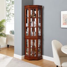 a corner cabinet with glass doors in a living room