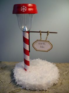 a red and white pole with a hat on top