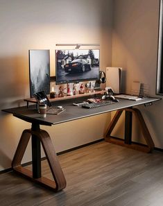 a desk with a computer on it in front of a window