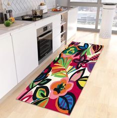 a kitchen area rug with colorful flowers on it