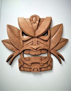 a carved wooden mask on a white background