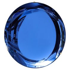 a round blue glass object on a white background