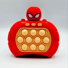 an electronic toy with a spiderman face on it's head and circles in the middle