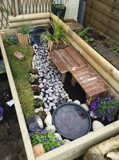 a small garden with rocks and plants in the center, along with a wooden bench