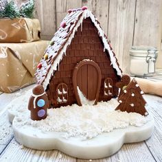 a gingerbread house made to look like it is in the snow